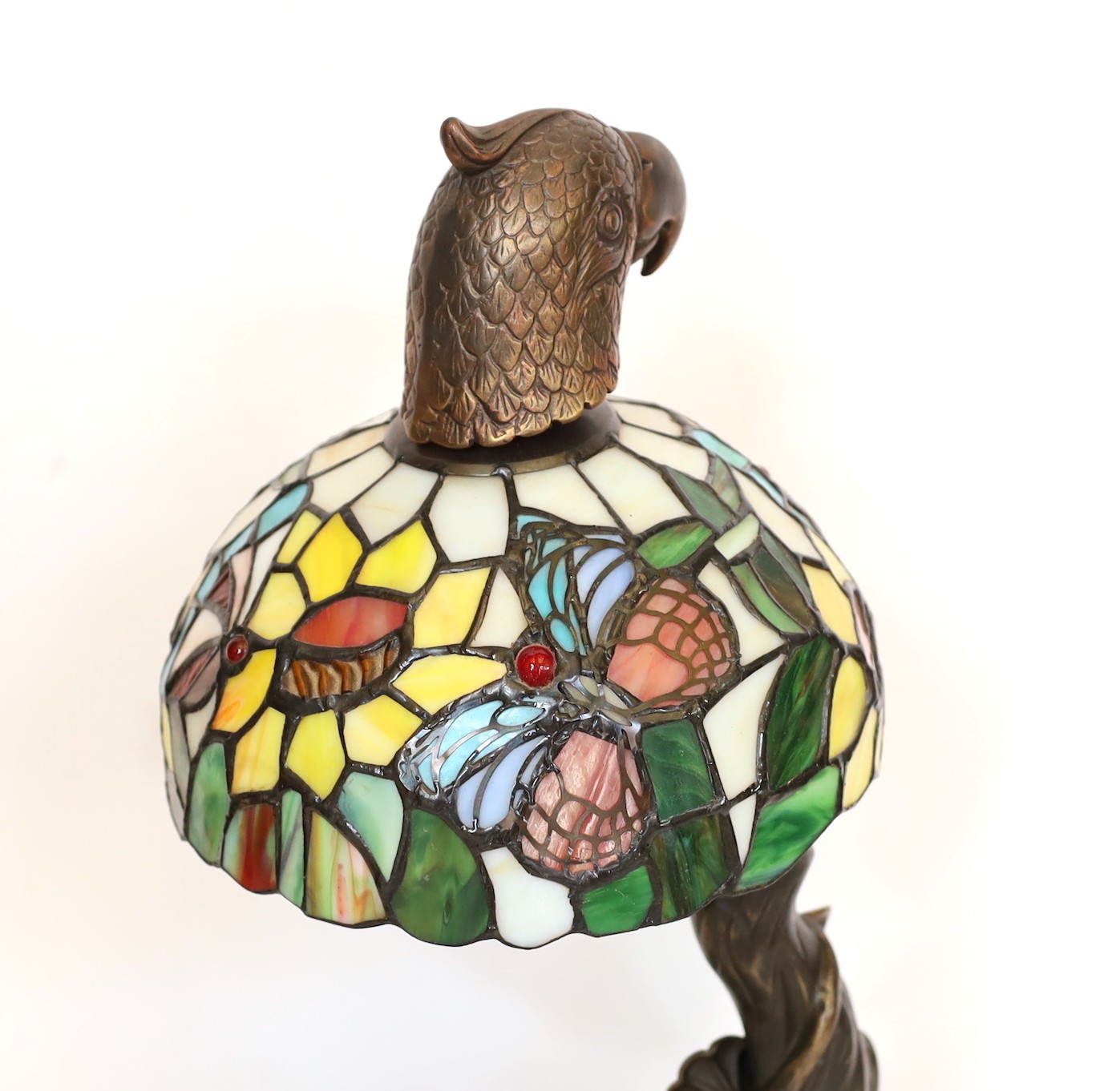 A bronze, stained glass and marble table lamp modelled as a flowering tree with parrot head, height 44cm